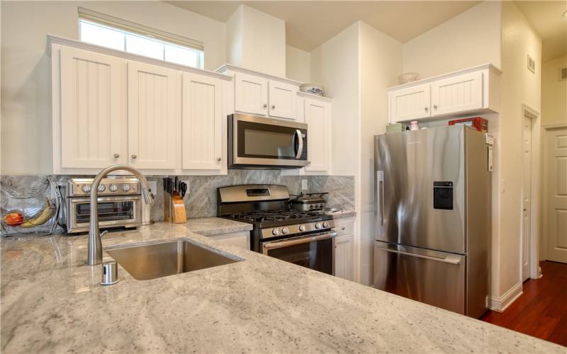 Top of the line stainless appliances include Fisher & Paykel refrigerator and two drawer dishwasher, GE 5 burner gas range with grill, Stainless farmhouse sink and quartz counters.