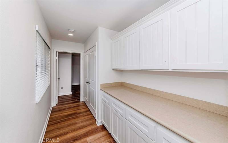 Plenty of storage cabinets and counter space adjacent to Laundry.