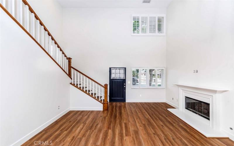 Living room feature  2 story high ceilings and a gas fireplace.