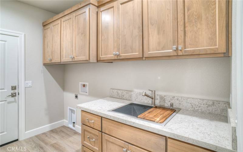 laundry room with utility sink and lots of storage