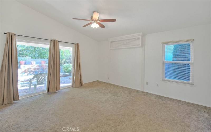 Primary bedroom with sliding door to the​​‌​​​​‌​​‌‌​​‌​​​‌‌​​​‌​​‌‌​​‌‌​​‌‌​​​​ patio