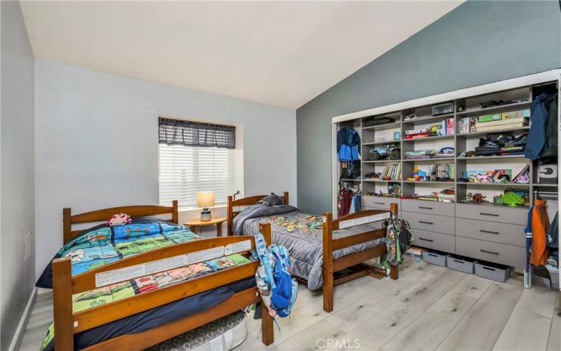 Bedroom three with built in closet cabinetry.