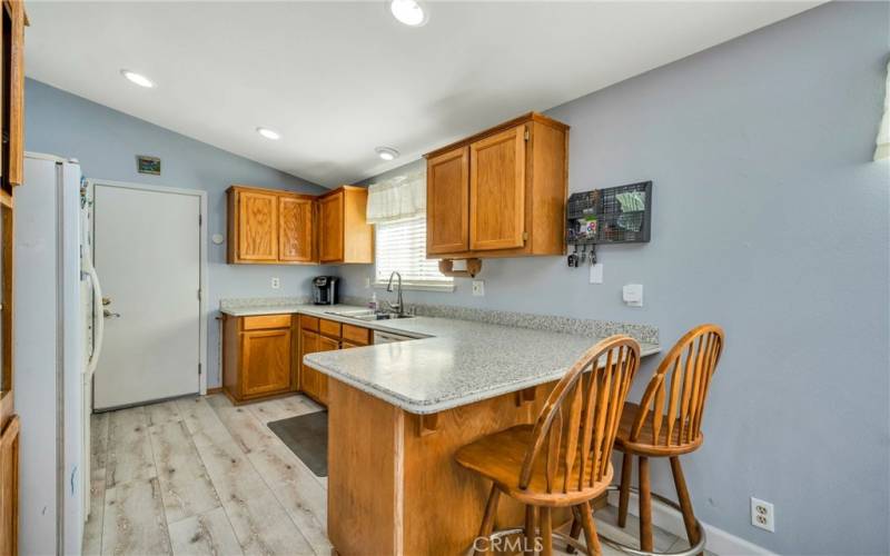 Open kitchen with vaulted ceiling.