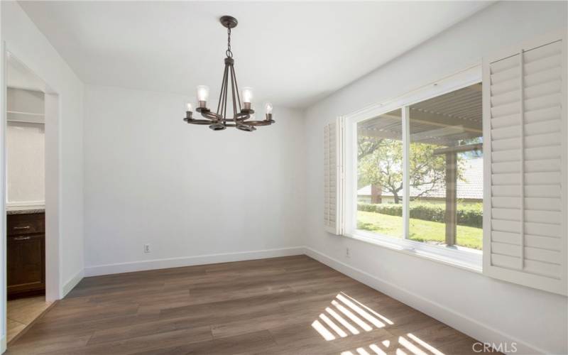 Dining Room area with plenty of natural light from window overlooking backyard patio and green belt area