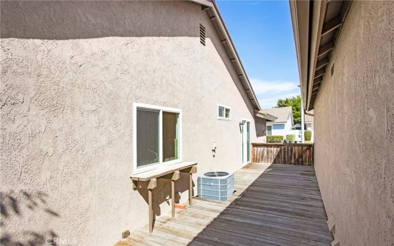 Side deck patio area with gated access to front yard