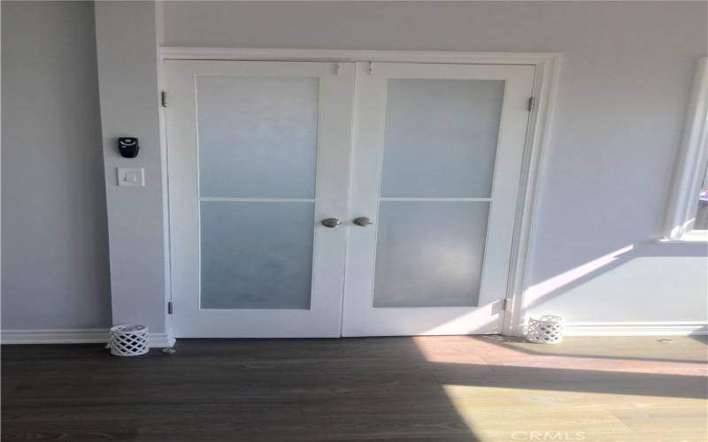 French doors of bedroom leading to living room