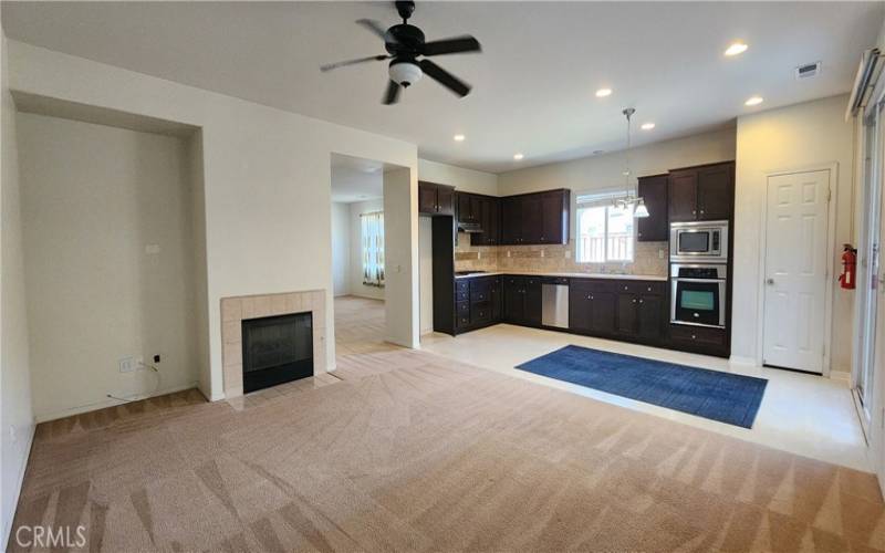 open layout family room and kitchen before the new flooring