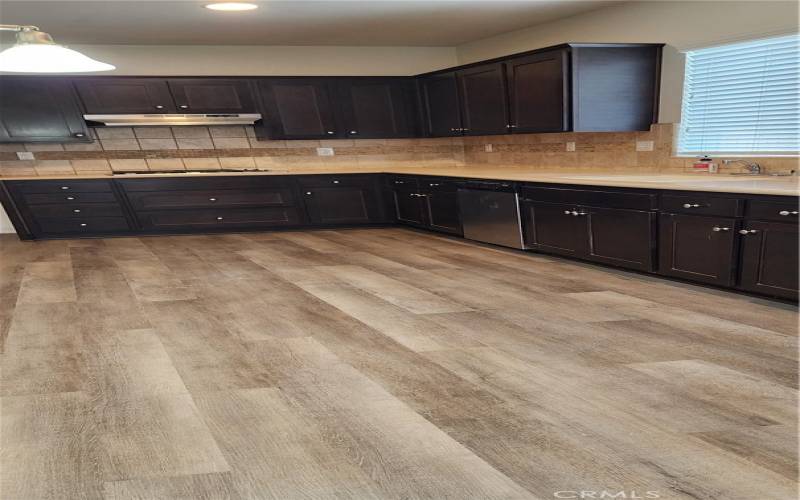 Gorgeous newly installed laminated wood complimenting the gourmet kitchen