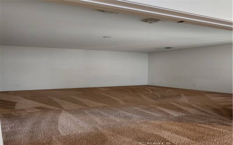 Front bedroom across living room w/ high ceiling