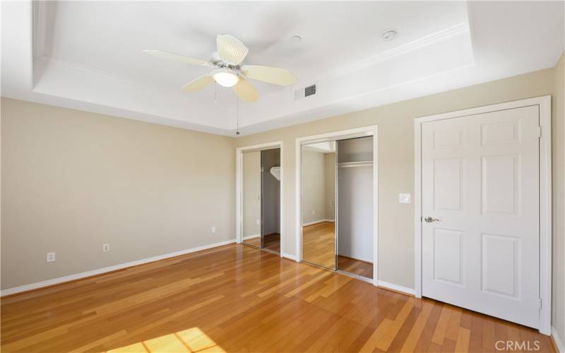 The tray ceiling and mirrored wardrobes gives this BEDROOM a spacious feel