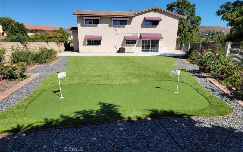 Backyard with Brand-New Artificial Turf and Two-Hole Putting Green