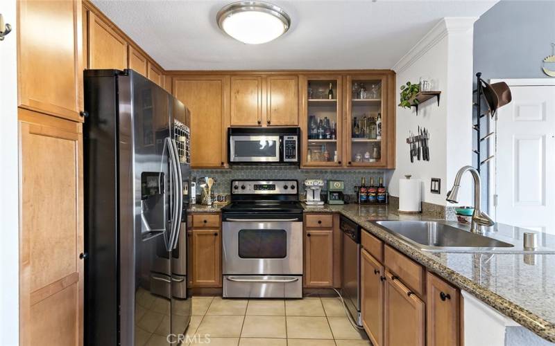 Kitchen with granite countertops stainless steele stove, built in microwave and dishwasher