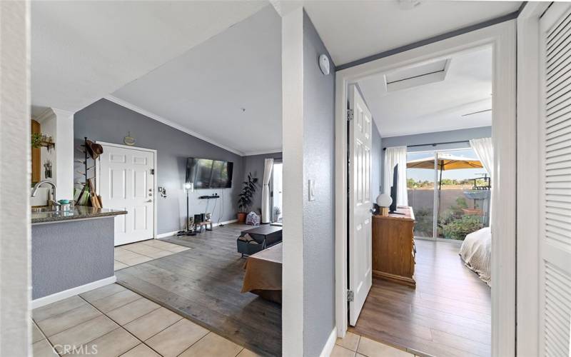 View of the living room and bedroom entry from the hall