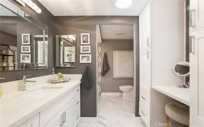 Second Level Dual Suite Bath with New Cabinetry, Updated Lighting and Mirrors, Mannington Waterproof LVT Tile, and Make Up Counter.