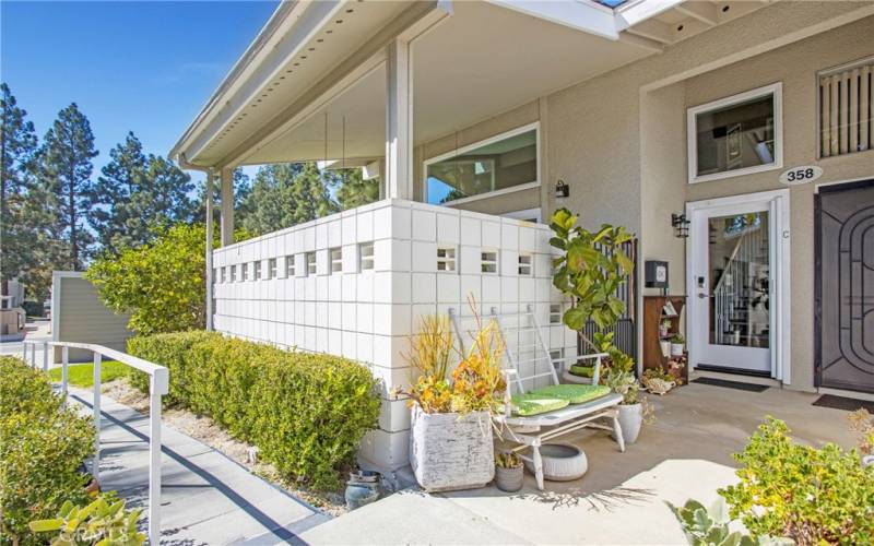 Seville 2 Entry with Newer Entry Door and Retractable Screen.  Covered Patio.