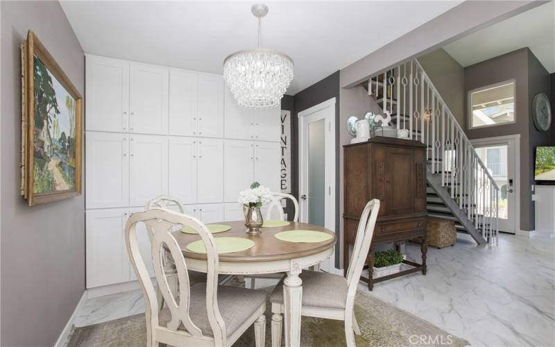 Dining Area.  Custom Lighted Pantry with Frosted Glass Door.