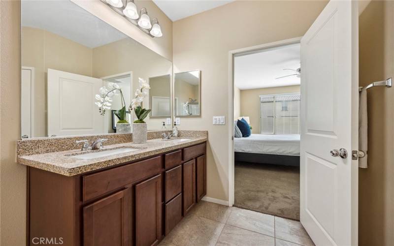 Double sinks in primary bathroom with granite counter top