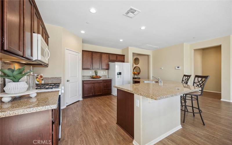 Upgraded dark kitchen cabinets with granite counter tops. Lots of storage space!