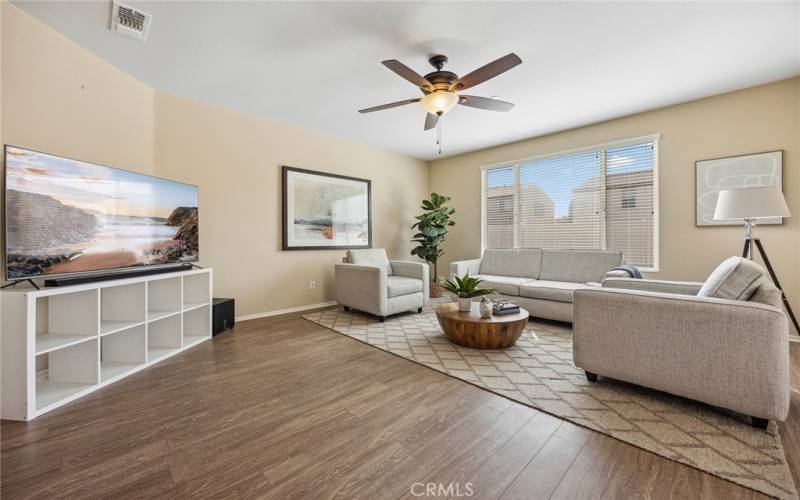 Your huge great room with ceiling fan and view of your backyard.