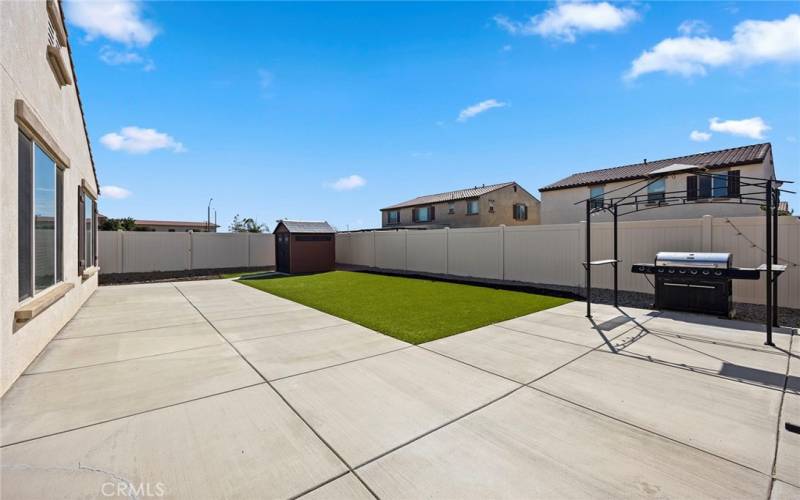 Spacious, low maintenance back yard. Concrete padding, artificial grass along with a gazebo