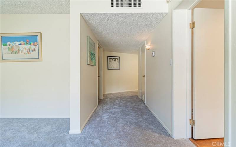 Master bedroom hallway to walk-in closet, sauna, and bathroom