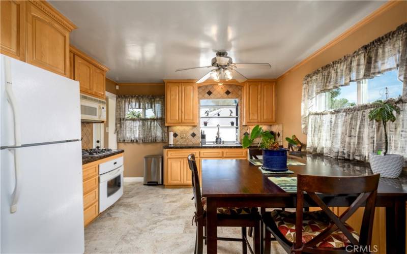 Updated kitchen with granite tile counters and custom cabinets