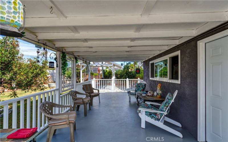 The covered patio off of the garage is a great place for entertaining - out of the heat and sun, or wet rain