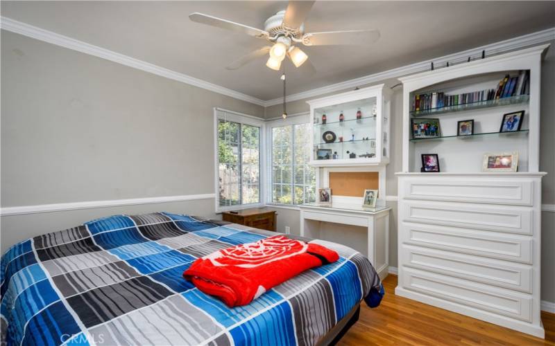 Bedroom 2 is east facing and complimented by built in dresser/bookshelf and desk