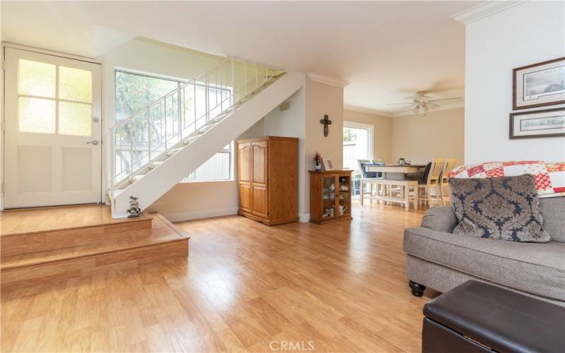 Stairs near the front door lead to bedrooms and bath upstairs.