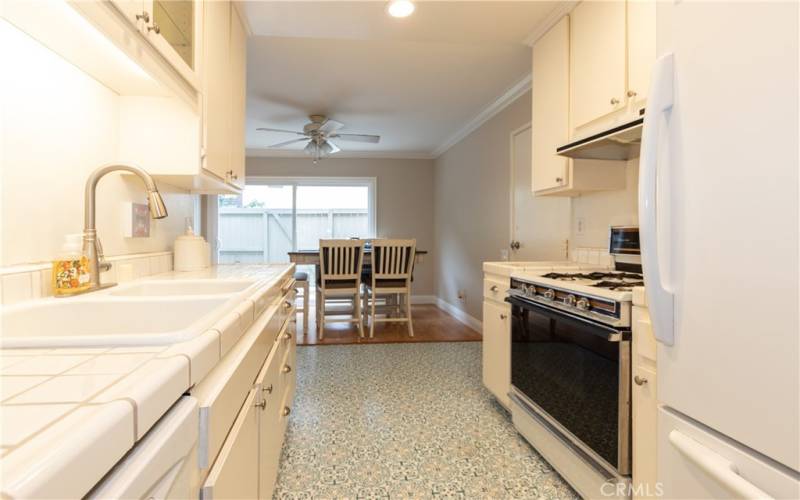 Pantry cupboards and a closet at this end of the kitchen, dining room at the far end.