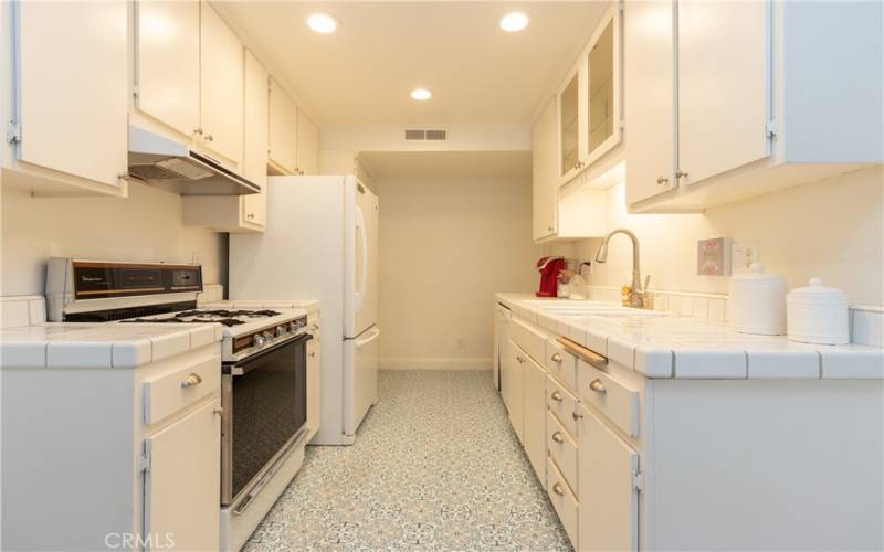 Pullman kitchen with decorative flooring.