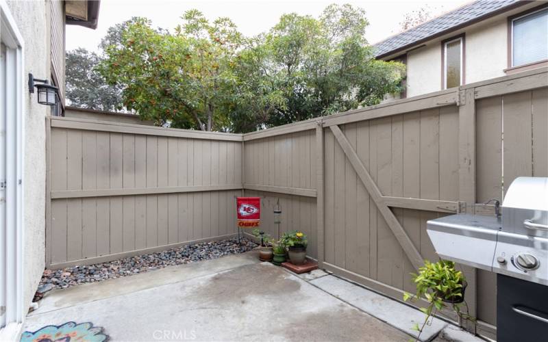 Neat, clean patio with gate to outside.