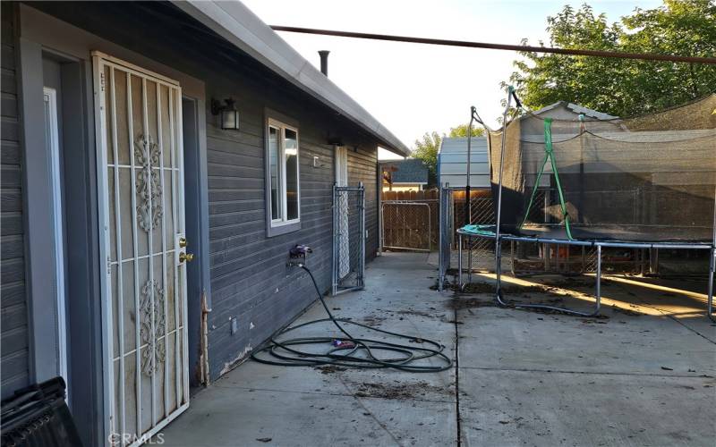 Back yard looking towards carport cover.