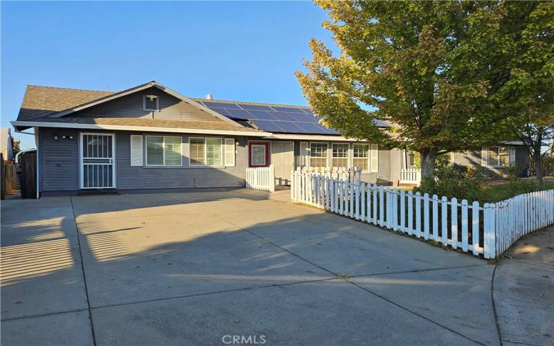 Driveway looking at home with solar on roof