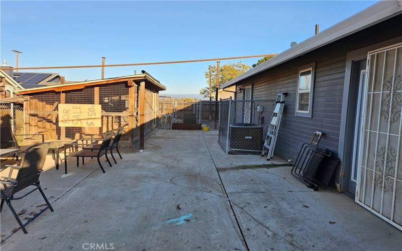 Back yard cement patio with aviary