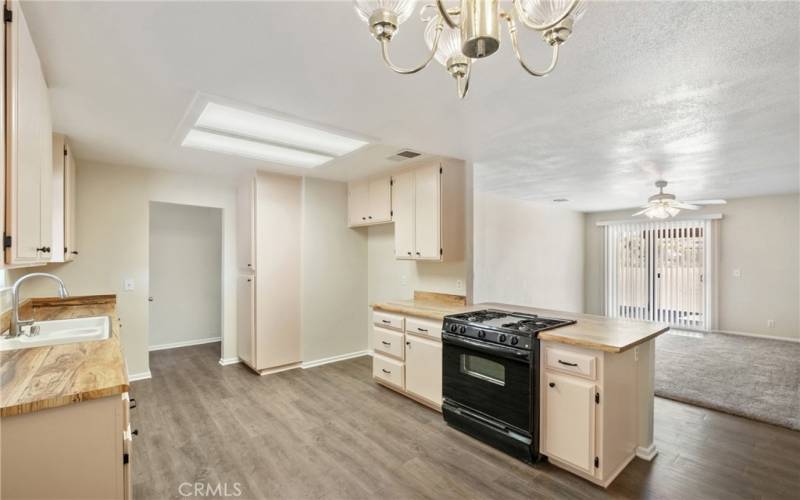 view from kitchen to family room and fireplace as well as slider to rear yard