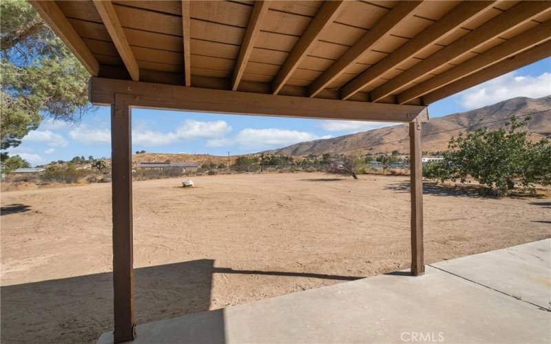 rear covered patio overlooking large rear yard