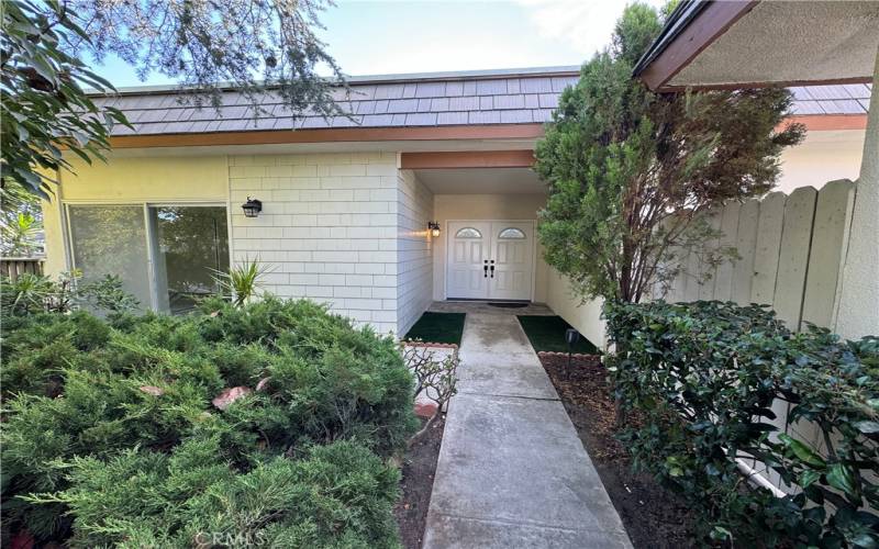 Front court yard makes this home very charming.