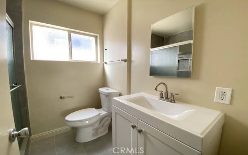 Bathroom remodeled with vanity and mirror