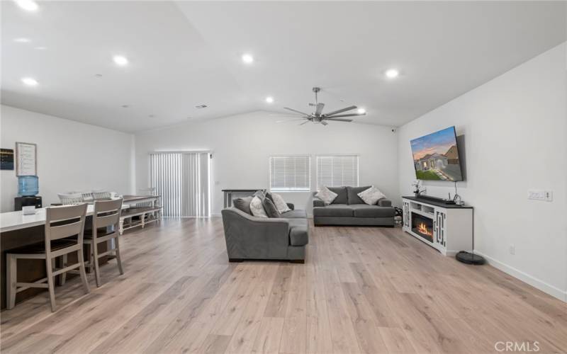 Great room open to the eat in kitchen. Custom fan and fireplace.