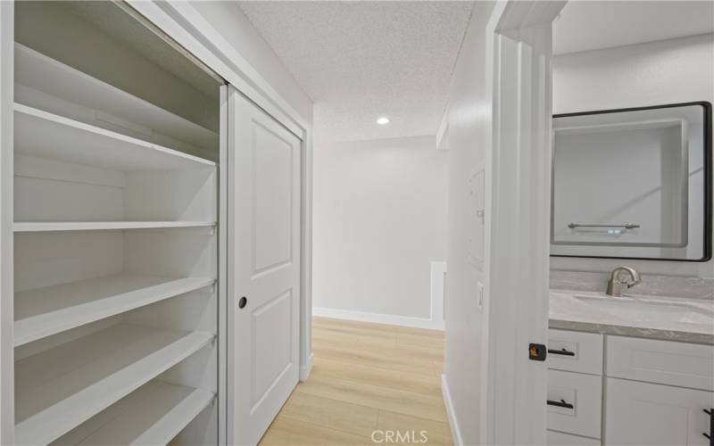 hall closet with shelves for storage.