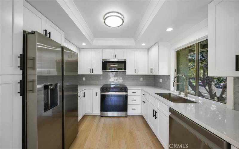 Pantry, on left of refrigerator with ice/water in door, tile back splash.