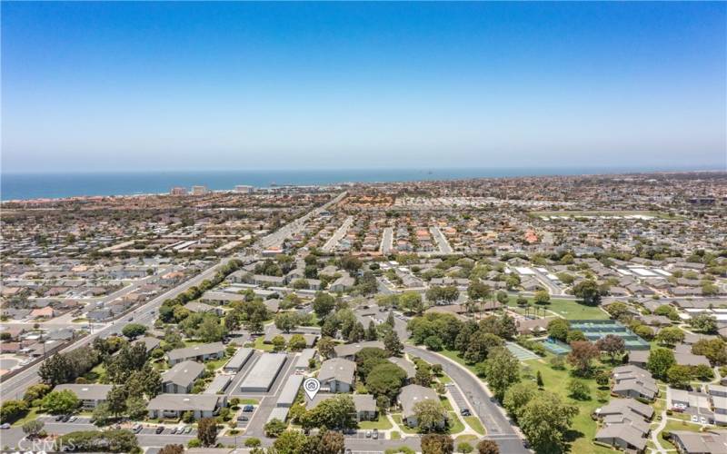 drone shot of the community in relation to city street and ocean