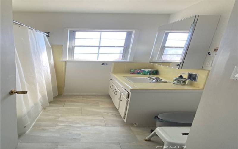 Hall Bath with procelain tub and newer vinyl floor