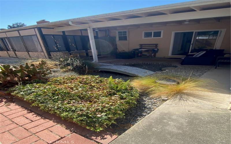 Back yard view to enclosed patio