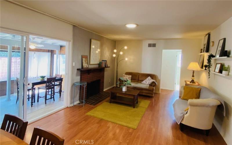 View of living room with skylight, access to enclosed patio thru extra wide sliding door