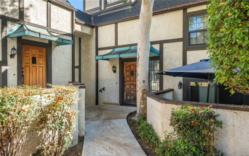 Tudor-style front entrance with greenery