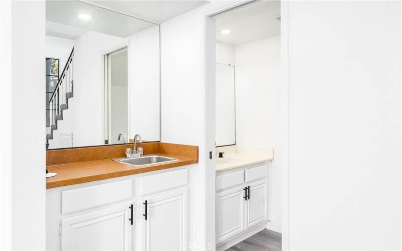 Vanity area with sink and mirror