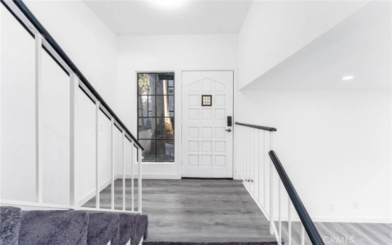 Bright entryway with modern stairs