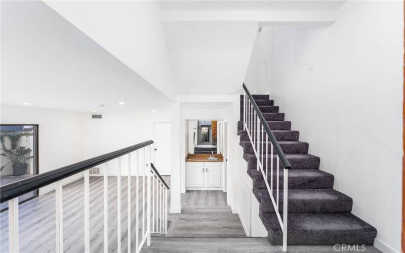 Carpeted staircase leading to 2nd level